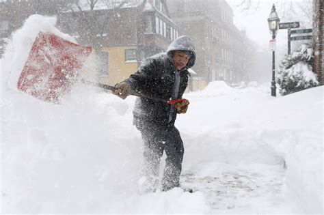 A Man Shovelling Snow After a Blizzard