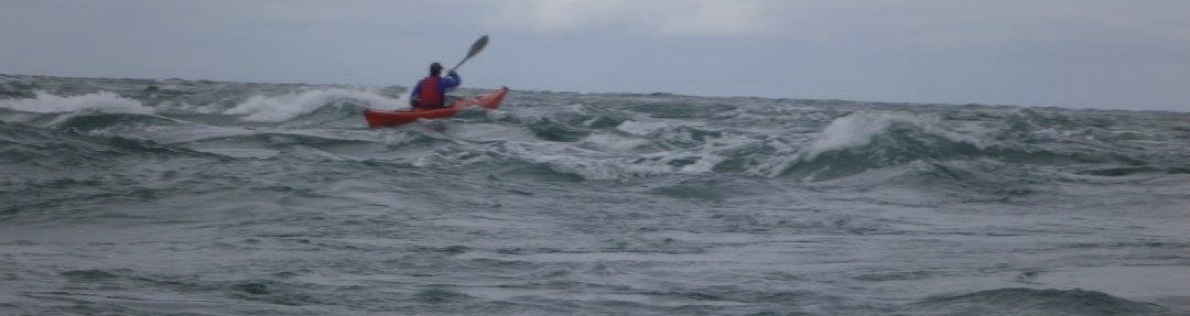 Photograph of the tide race at Penrhyn Mawr. Contrast the smooth eddy in the foreground with the rough water in the tidal stream (going left to right).