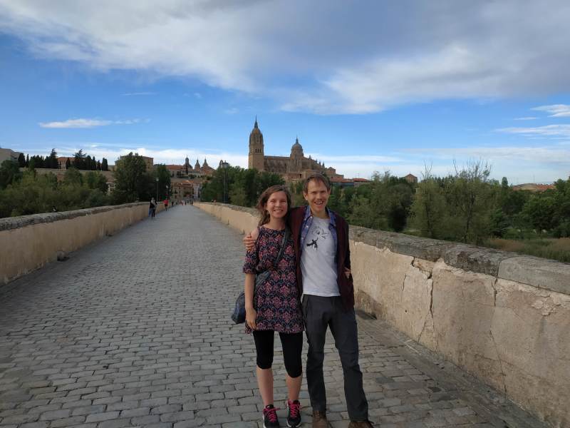 Us on the historic bridge, with the main cathedral of Salamanca in the background